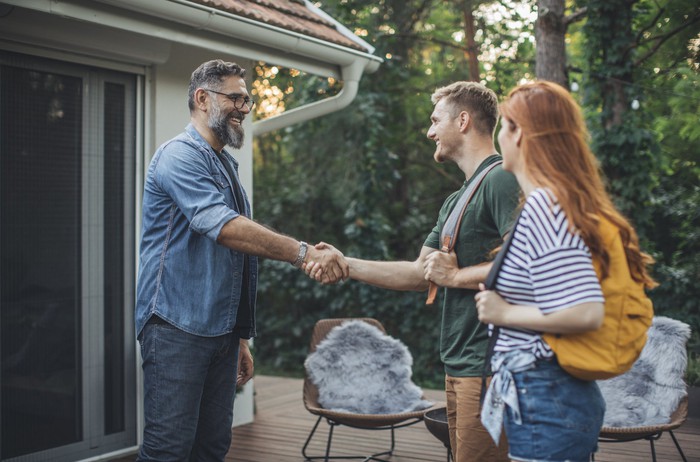 People greeting each other by shaking hands.